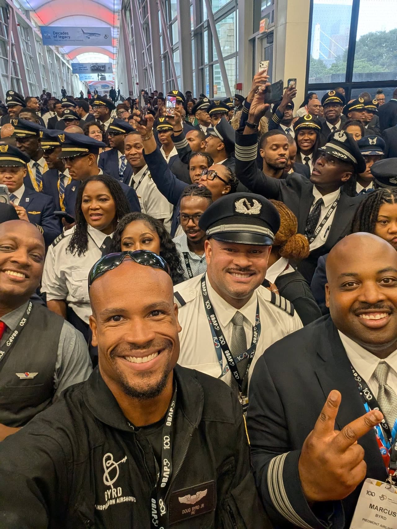 Doug Byrd in a selfie with a large group of uniformed pilots at the OBAP convention.