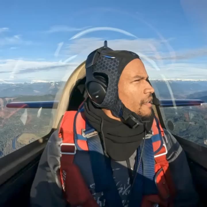 Doug Byrd in the cockpit of the Extra 300L with his headset on.