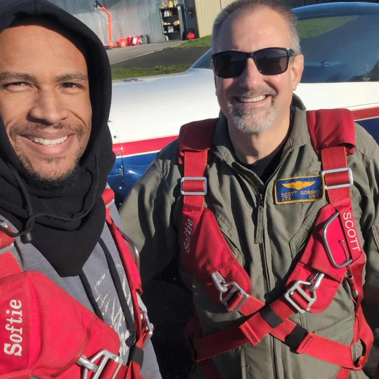 Doug Byrd and Scott Gorski in flight gear beside the Extra 300L.