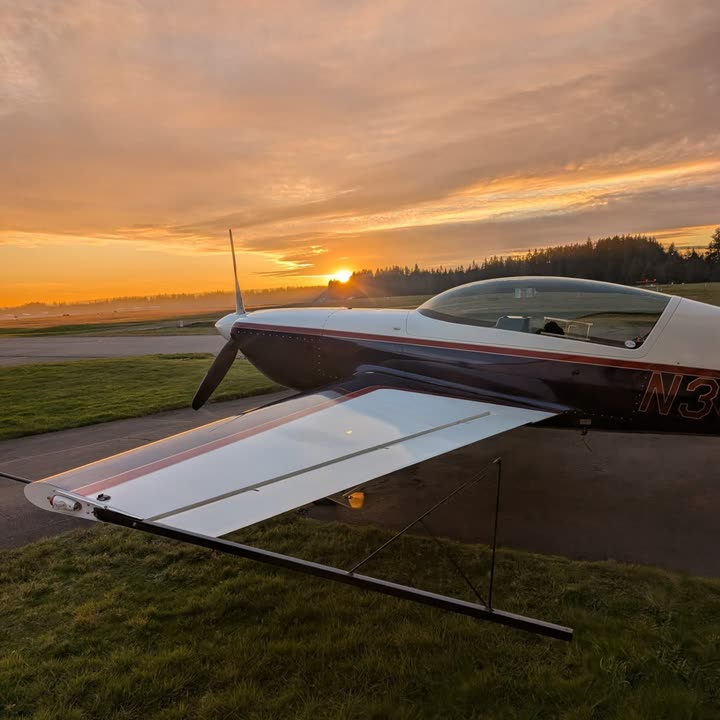 The Extra 300L parked on the ramp at sunset.