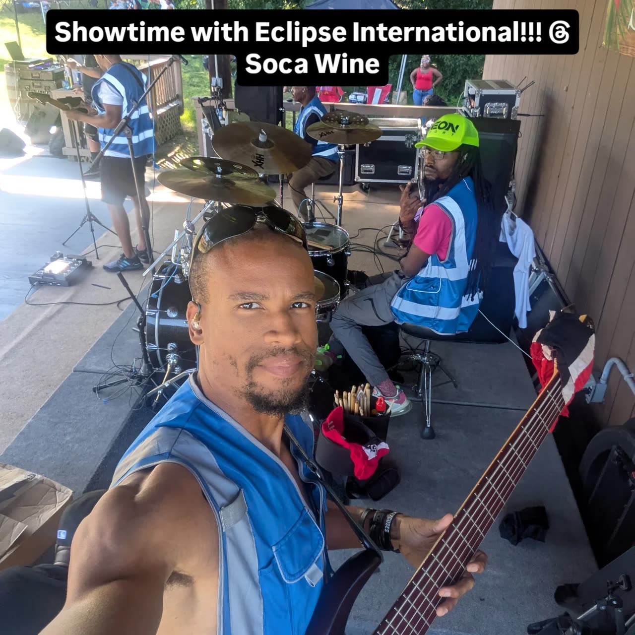 Doug Byrd with a five-string bass on stage with Eclipse International, the drummer and the rest of the band behind him. Overlaid text reads: Showtime with Eclipse International!!! Soca Wine.
